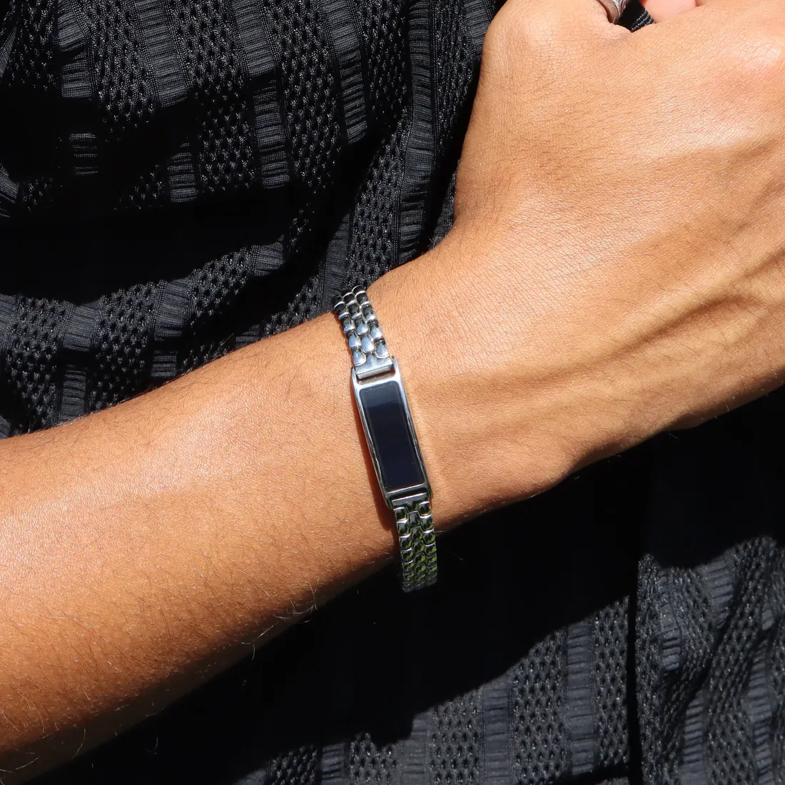 Ray in Moonlit Silver on a steel link band, worn on the wrist